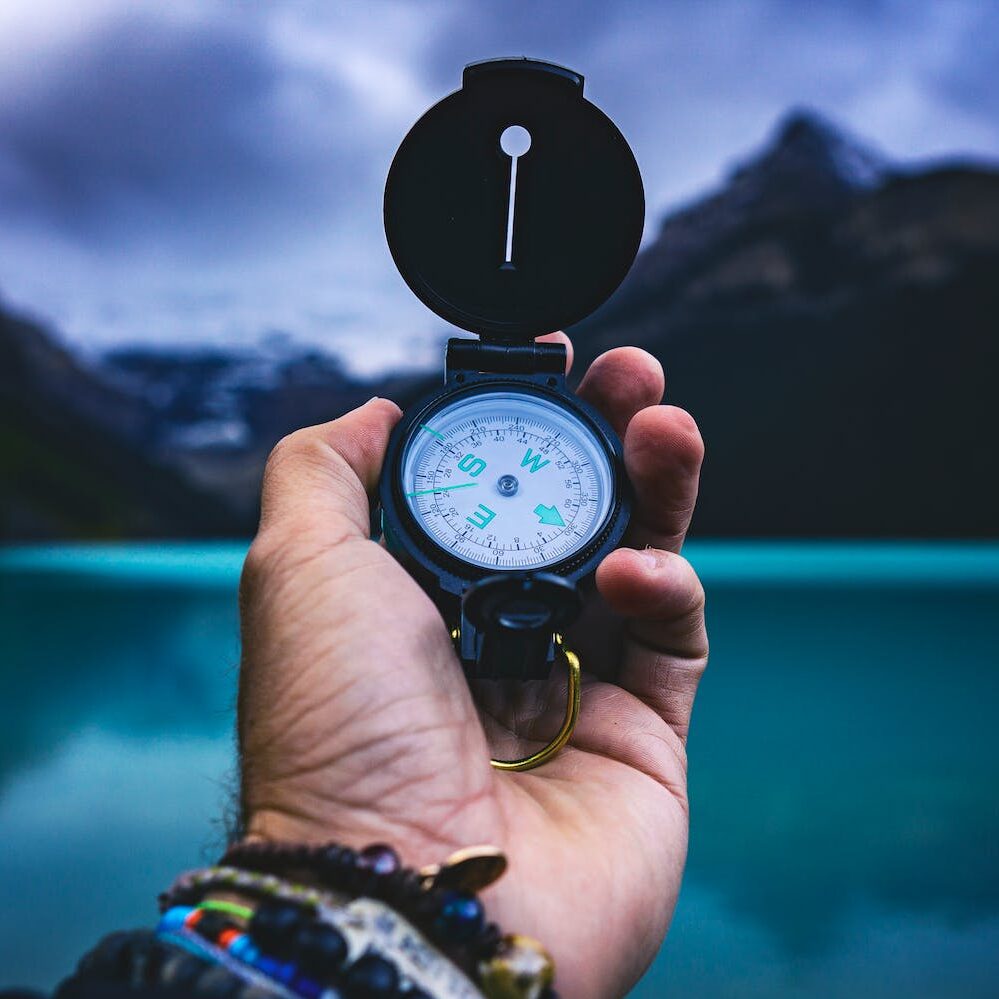 person holding a compass
